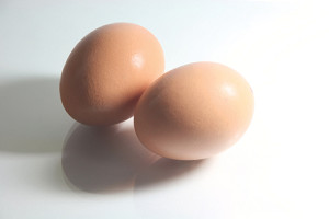 two eggs with hard shadow and reflection